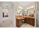 Spacious bathroom vanity with large mirrors, a makeup counter and great light and views into the Primary bedroom at 5910 La Rosa Ln, Apollo Beach, FL 33572