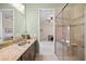 Bathroom with a single sink vanity, a granite countertop, and walk-in shower with glass doors at 5910 La Rosa Ln, Apollo Beach, FL 33572