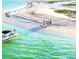 Scenic beach with a boat on the water and group of people enjoying the sunny day at the shore at 5910 La Rosa Ln, Apollo Beach, FL 33572