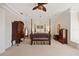 Spacious bedroom featuring a four-poster bed, elegant furnishings, and a ceiling fan for added comfort at 5910 La Rosa Ln, Apollo Beach, FL 33572