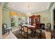 Elegant dining room featuring a chandelier, large windows, and a decorative china cabinet at 5910 La Rosa Ln, Apollo Beach, FL 33572