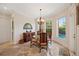 Bright dining room with a chandelier, windows with a view, and stylish decor for elegant dining at 5910 La Rosa Ln, Apollo Beach, FL 33572