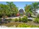 Inviting entrance to Circles waterfront restaurant with lush tropical landscaping and unique decor at 5910 La Rosa Ln, Apollo Beach, FL 33572