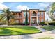 Stunning two-story home features a terracotta facade, lush landscaping, and a grand entrance at 5910 La Rosa Ln, Apollo Beach, FL 33572