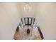 Grand foyer with decorative tile flooring, a crystal chandelier and a pair of wood and glass doors at 5910 La Rosa Ln, Apollo Beach, FL 33572