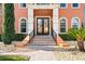 Elegant front entrance with double doors, brick steps, and manicured landscaping showcasing curb appeal at 5910 La Rosa Ln, Apollo Beach, FL 33572