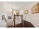 Bright hallway with wooden floors, white walls, decorated with art and a decorative light fixture at 5910 La Rosa Ln, Apollo Beach, FL 33572