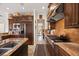 The chef's kitchen is complete with stainless steel appliances, granite countertops, and custom cabinetry at 5910 La Rosa Ln, Apollo Beach, FL 33572