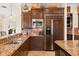 Gourmet kitchen features stainless appliances, granite countertops, and custom cabinets for a modern appeal at 5910 La Rosa Ln, Apollo Beach, FL 33572