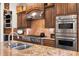 Close-up of the chef's kitchen featuring stainless steel appliances, granite countertops, and custom cabinetry at 5910 La Rosa Ln, Apollo Beach, FL 33572