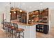 Gourmet kitchen with dark wood cabinets, granite countertops, stainless steel appliances, and bar stool seating at 5910 La Rosa Ln, Apollo Beach, FL 33572