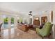 Spacious living room with doors to the lanai and pool area, and elegant decor at 5910 La Rosa Ln, Apollo Beach, FL 33572