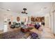 Inviting living room boasts beautiful marble floors, a ceiling fan, and is open to the gourmet kitchen at 5910 La Rosa Ln, Apollo Beach, FL 33572