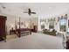 A spacious bedroom with a four-poster bed and a sitting area with bright natural light from bay windows at 5910 La Rosa Ln, Apollo Beach, FL 33572
