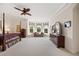 Spacious main bedroom with a four-poster bed, a sitting area, and many bright windows at 5910 La Rosa Ln, Apollo Beach, FL 33572