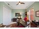 Office space with a ceiling fan, a red accent chair, and a window for natural light at 5910 La Rosa Ln, Apollo Beach, FL 33572