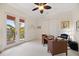 Bright office space with a wooden desk, closet, French doors to the outside and natural light at 5910 La Rosa Ln, Apollo Beach, FL 33572