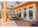 Inviting covered patio with ceiling fans, comfortable seating, and a serene outdoor dining area at 5910 La Rosa Ln, Apollo Beach, FL 33572
