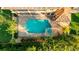 Aerial of a private backyard swimming pool with a spa, brick pavers, and tropical landscaping at 5910 La Rosa Ln, Apollo Beach, FL 33572