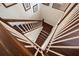 Elegant wooden staircase with white railings and decorative dark wood trim, a great home feature at 5910 La Rosa Ln, Apollo Beach, FL 33572