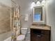 Bright bathroom featuring a granite countertop, vanity, decorative shower curtain, and neutral wall colors at 6527 Mayport Dr, Apollo Beach, FL 33572