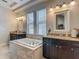 Modern bathroom features a soaking tub and granite counters on dark vanities at 6527 Mayport Dr, Apollo Beach, FL 33572