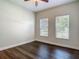 Bright bedroom with ceiling fan, wood floors, and two large windows providing lots of natural light at 6527 Mayport Dr, Apollo Beach, FL 33572