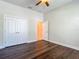 Cozy bedroom showcasing wood floors, double closets, and a view into the adjoining bathroom at 6527 Mayport Dr, Apollo Beach, FL 33572