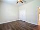 Bright bedroom featuring wood floors, double door closet, and ceiling fan at 6527 Mayport Dr, Apollo Beach, FL 33572