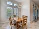 Charming dining room with natural light from tall windows and a stylish chandelier over a wood dining table at 6527 Mayport Dr, Apollo Beach, FL 33572