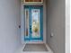 Inviting front door with decorative glass and blue trim, enhancing curb appeal at 6527 Mayport Dr, Apollo Beach, FL 33572