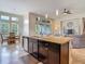 Bright kitchen with large island, pendant lighting, and an open view into the living room at 6527 Mayport Dr, Apollo Beach, FL 33572