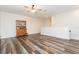 Bright living room featuring wood floors, a ceiling fan, and a charming china cabinet at 6527 Mayport Dr, Apollo Beach, FL 33572