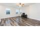 Large living room with wood flooring, a ceiling fan, and natural light from multiple windows at 6527 Mayport Dr, Apollo Beach, FL 33572