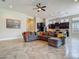 Spacious living area with kitchen view, a sectional sofa, and tile flooring at 6527 Mayport Dr, Apollo Beach, FL 33572