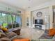 Bright living room with access to patio, tile floors, and a sleek entertainment center for modern appeal at 6527 Mayport Dr, Apollo Beach, FL 33572