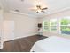 This main bedroom boasts natural light and dark hardwood floors at 6527 Mayport Dr, Apollo Beach, FL 33572