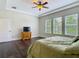 Spacious bedroom with hardwood floors, a ceiling fan, and three large windows at 6527 Mayport Dr, Apollo Beach, FL 33572