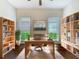 Stylish home office with hardwood floors, built-in shelves, and a large window for ample light at 6527 Mayport Dr, Apollo Beach, FL 33572