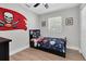 Comfortable bedroom with sports-themed decor, including a Tampa Bay Buccaneers flag and sports bedding at 7000 10Th N St, St Petersburg, FL 33702