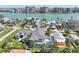 Stunning waterfront home with private pool, lush landscaping, and breathtaking views of the bay and nearby city skyline at 720 Bay Esplanade, Clearwater Beach, FL 33767