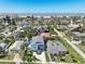 An aerial view of the neighborhood, showcasing homes, mature trees and beach, offering a glimpse of the community's appeal at 720 Bay Esplanade, Clearwater Beach, FL 33767