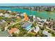 A bright blue waterfront home with a pool and easy access to the bay in a tropical setting at 720 Bay Esplanade, Clearwater Beach, FL 33767