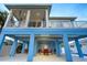 Spacious backyard with stilt architecture, covered patio, and comfortable seating at 720 Bay Esplanade, Clearwater Beach, FL 33767