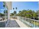 Second story balcony showcasing beautiful views of palm trees and lush landscaping at 720 Bay Esplanade, Clearwater Beach, FL 33767