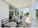 Charming balcony with rocking chairs featuring tile flooring and sliding glass doors for indoor-outdoor living at 720 Bay Esplanade, Clearwater Beach, FL 33767