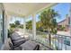 Relaxing balcony with outdoor seating and a view of lush tropical landscaping and swaying palm trees at 720 Bay Esplanade, Clearwater Beach, FL 33767