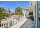 Second story balcony featuring views of the neighborhood and swaying palm trees at 720 Bay Esplanade, Clearwater Beach, FL 33767