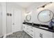 Bright bathroom features dual sinks, black granite countertops, and decorative tile flooring at 720 Bay Esplanade, Clearwater Beach, FL 33767
