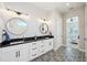 Well-lit bathroom with double vanity, granite countertops, and decorative tile flooring at 720 Bay Esplanade, Clearwater Beach, FL 33767